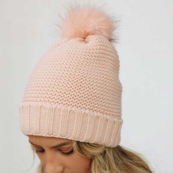 Knit Pom Pom beanie with plush lining.
